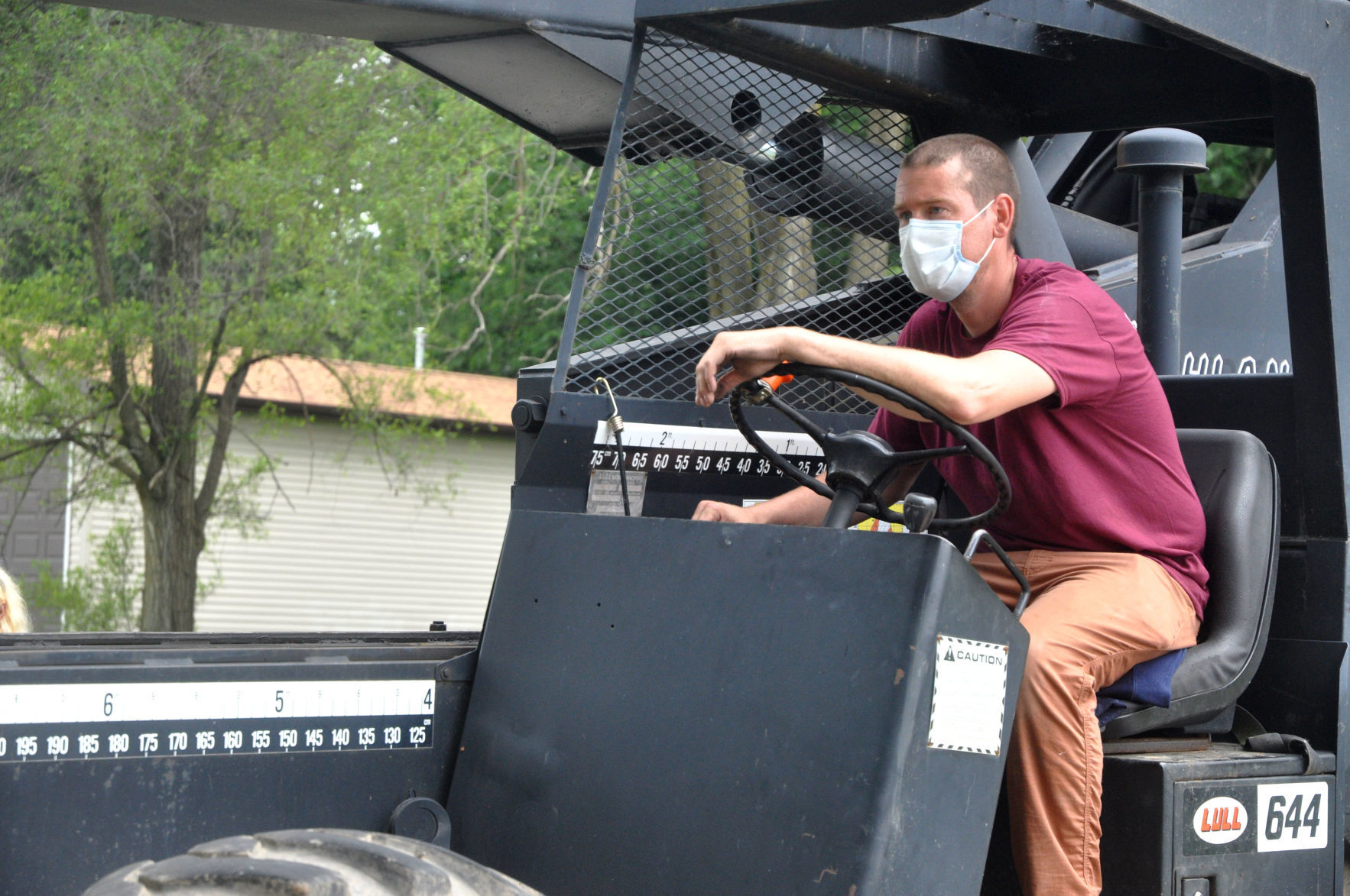 Myles Swanson prepares to lift a military statue onto a forklift
